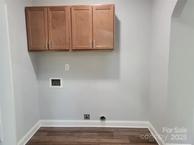 a view of storage and utility room with wooden floor
