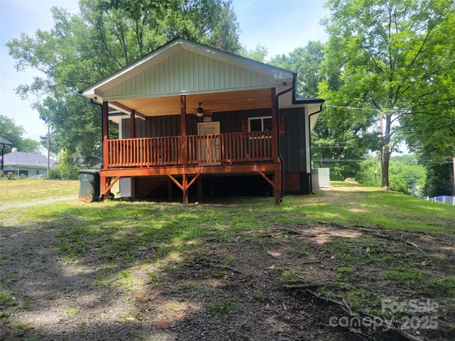 a view of a house with yard and a slide