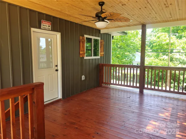 a view of a porch with wooden floor and outdoor space