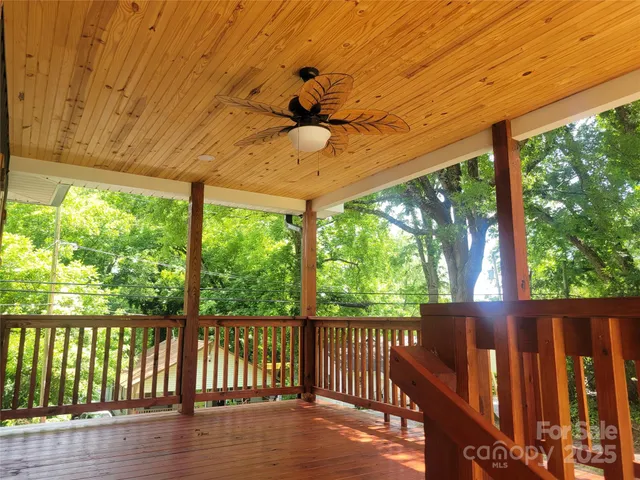 a view of a porch with wooden floor and outdoor space
