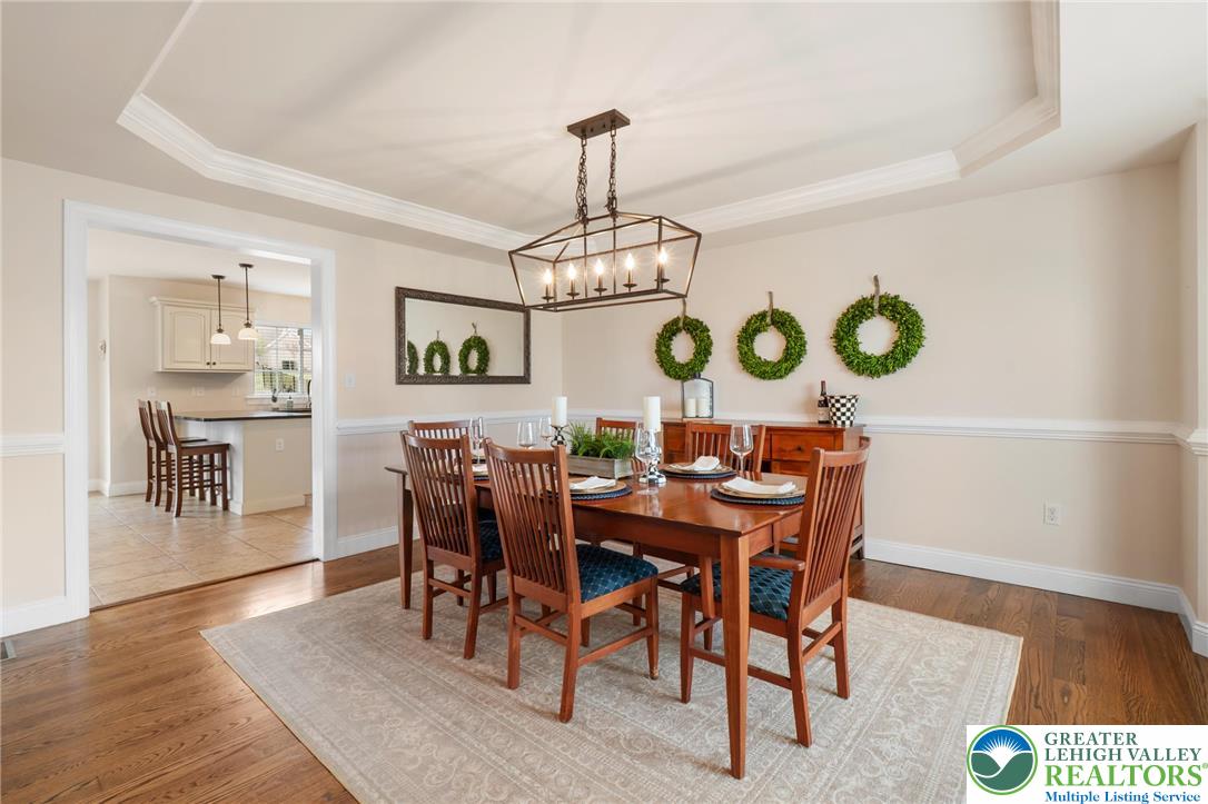 208 East Dell Road Bath, PA 18014 - Photo 7 of 40 a view of a dining room and livingroom with furniture wooden floor a rug a painting and a chandelier