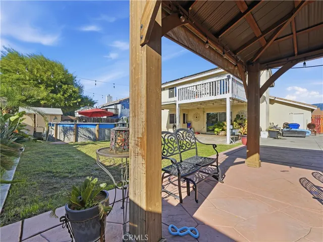 a view of a patio with chairs and potted plants