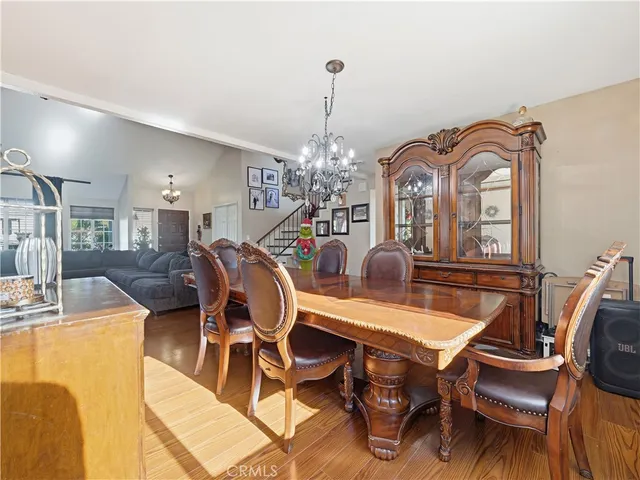 a view of a dining room with furniture and a chandelier