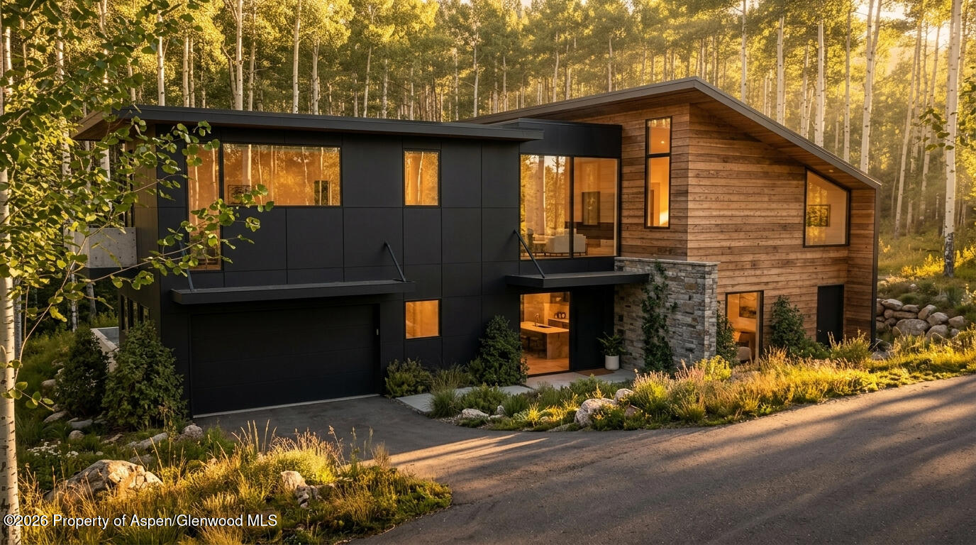 1265 Riverside Drive Aspen, CO 81611 - Photo 2 of 11 a front view of a house with a yard and garage