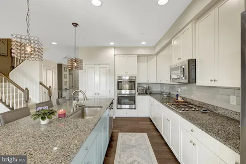 a kitchen with a counter top space appliances and cabinets