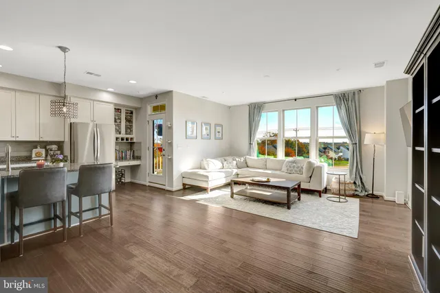 a living room with furniture and a book shelf