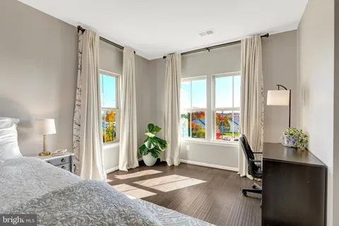 a spacious bedroom with a bed and a flat screen tv