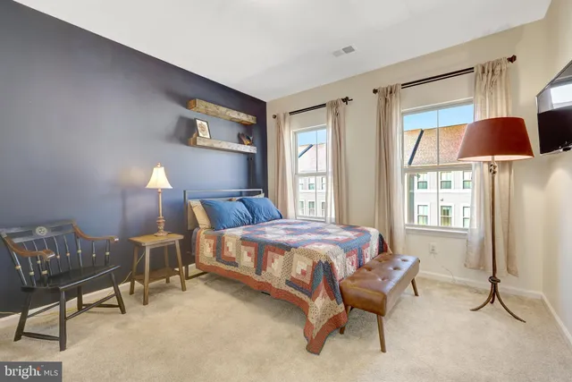 a bedroom with bed and painting on the wall