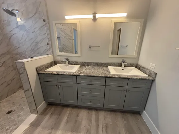 a bathroom with a double vanity sink and mirror