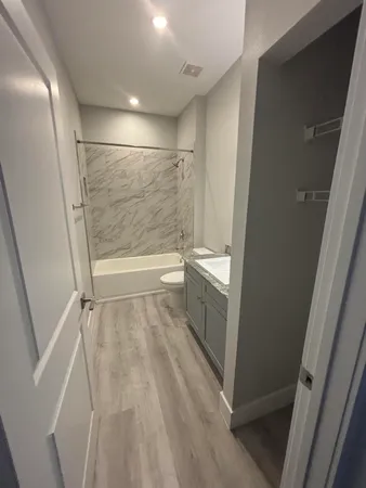 a bathroom with a bathtub and a shower