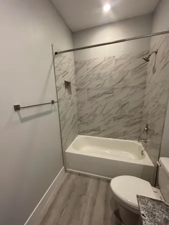 a bathroom with a toilet and a bath tub