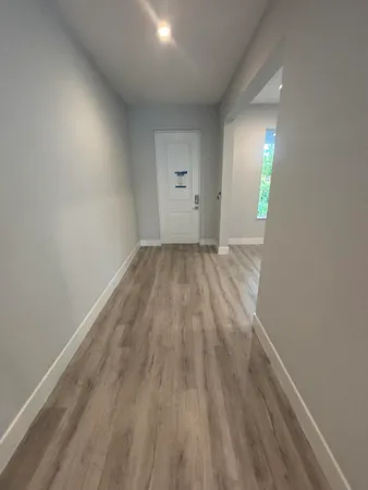 a view of an empty room and wooden floor