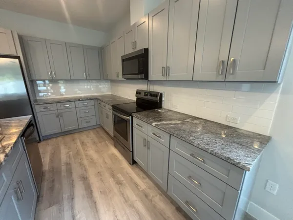 a kitchen with a sink stove and cabinets