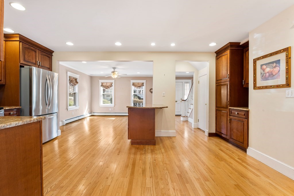 35 Lovell Road Watertown, MA 02472 - Photo 12 of 42 a living room with stainless steel appliances furniture wooden floor and a kitchen view