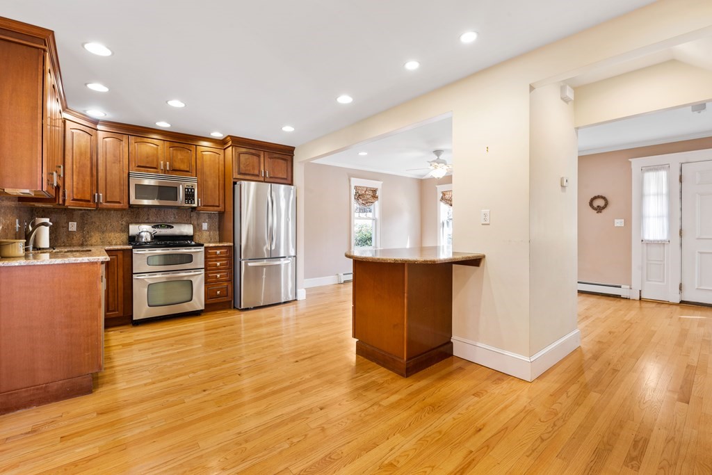 35 Lovell Road Watertown, MA 02472 - Photo 13 of 42 a view of kitchen with kitchen island wooden floor appliances and cabinets
