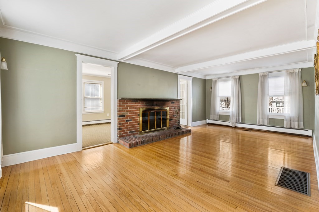 35 Lovell Road Watertown, MA 02472 - Photo 19 of 42 a view of a livingroom with wooden floor and a fireplace