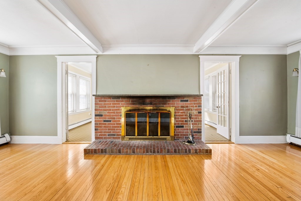 35 Lovell Road Watertown, MA 02472 - Photo 20 of 42 a view of an empty room with wooden floor and a fireplace
