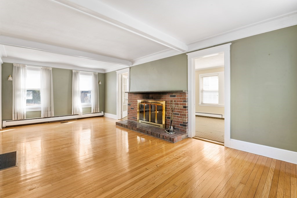 35 Lovell Road Watertown, MA 02472 - Photo 21 of 42 a view of a livingroom with wooden floor and a fireplace