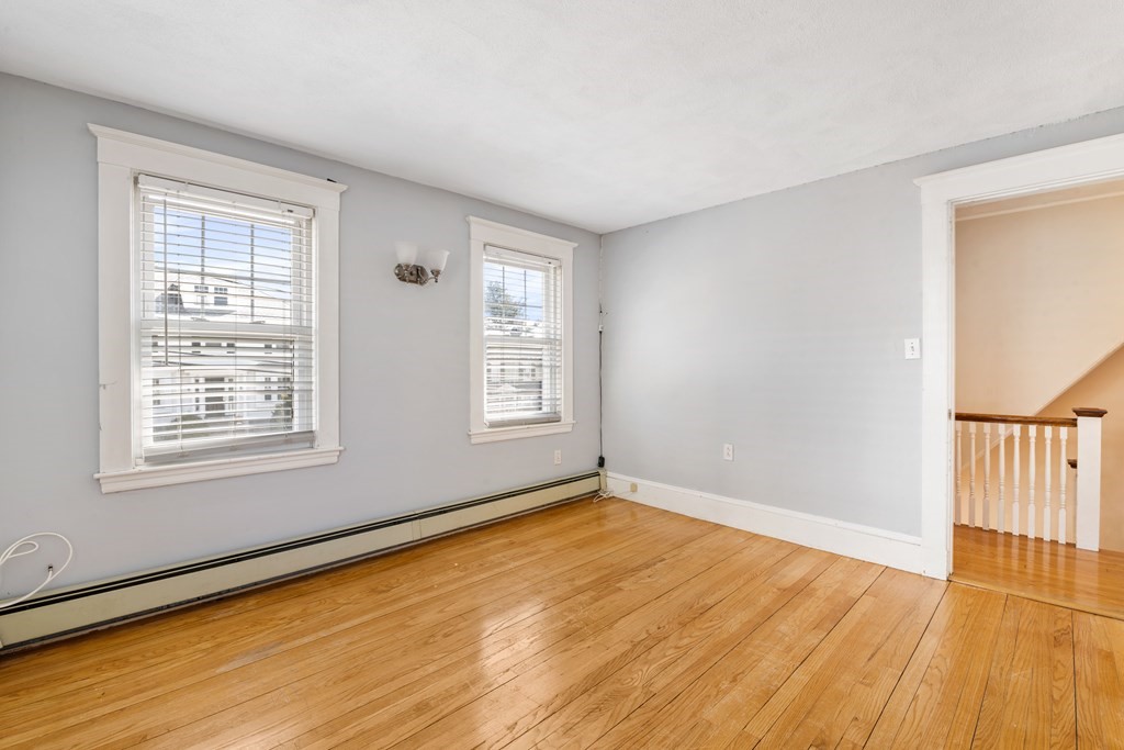 35 Lovell Road Watertown, MA 02472 - Photo 25 of 42 a view of an empty room with wooden floor and a window