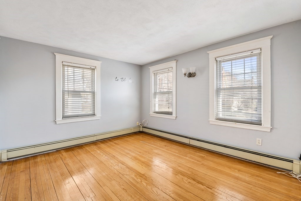 35 Lovell Road Watertown, MA 02472 - Photo 26 of 42 a view of an empty room with a window and wooden floor