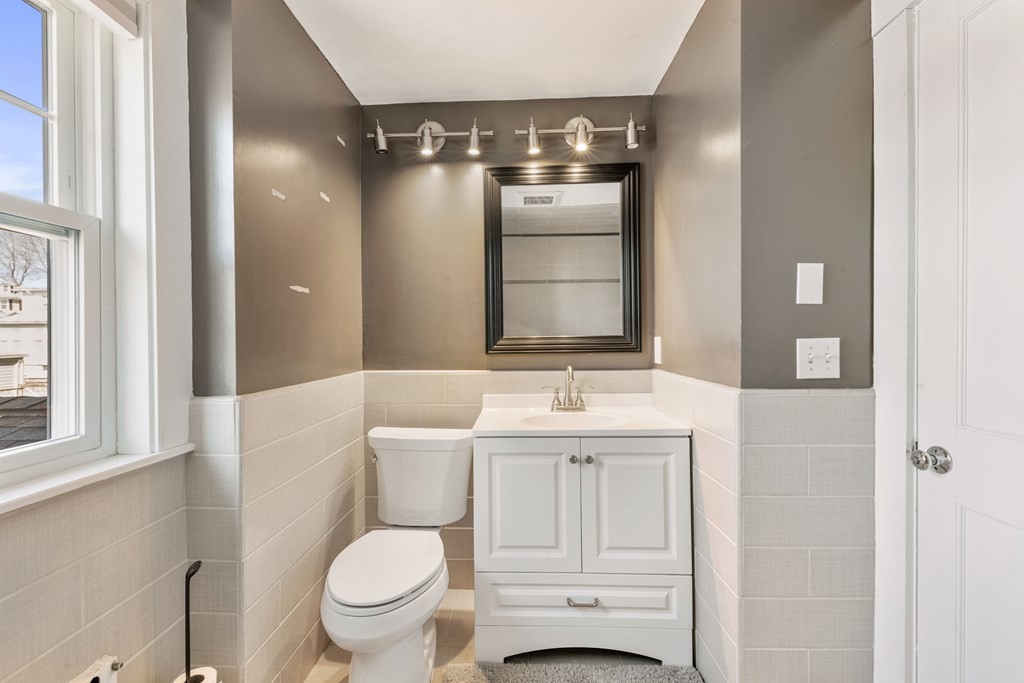 35 Lovell Road Watertown, MA 02472 - Photo 29 of 42 a bathroom with a toilet sink and mirror