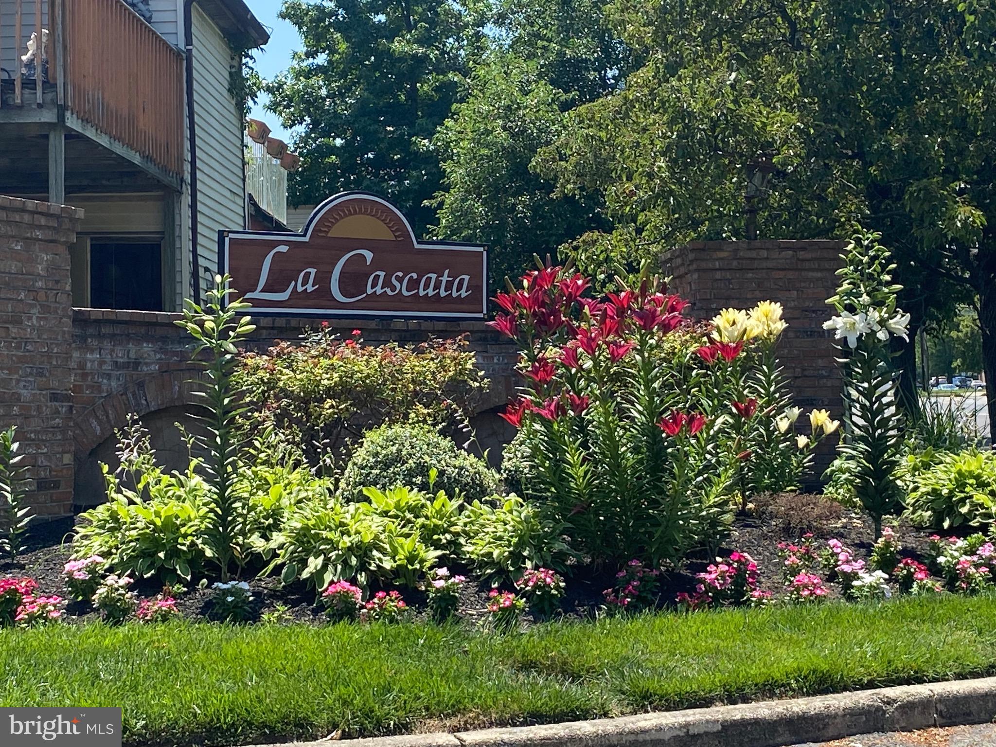 455 Via Cascata Drive Clementon, NJ 08021 - Photo 2 of 3 a sign that is sitting in front of flowers