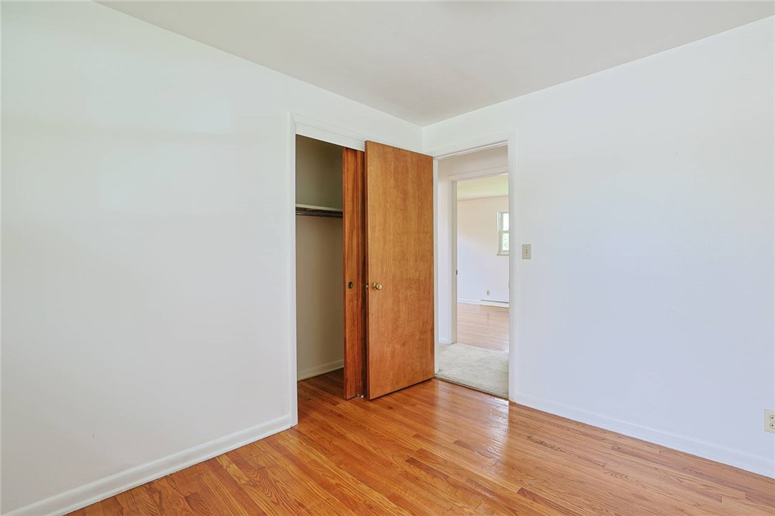 452 Cookston Avenue Springfield, OH 45503 - Photo 19 of 34 This spacious bedroom features warm hardwood floors and a convenient closet, offering comfort and practicality.
