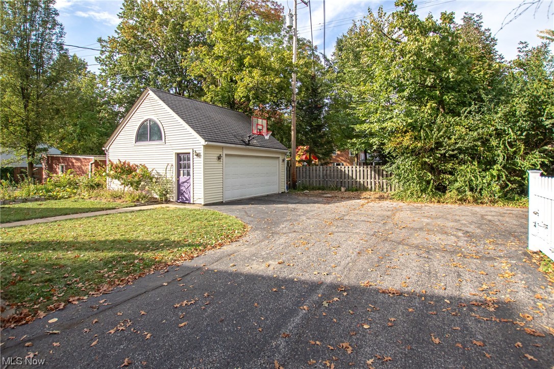 15911 Fernway Road Cleveland, OH 44120 - Photo 28 of 32 View of garage with basketball hoop and driveway