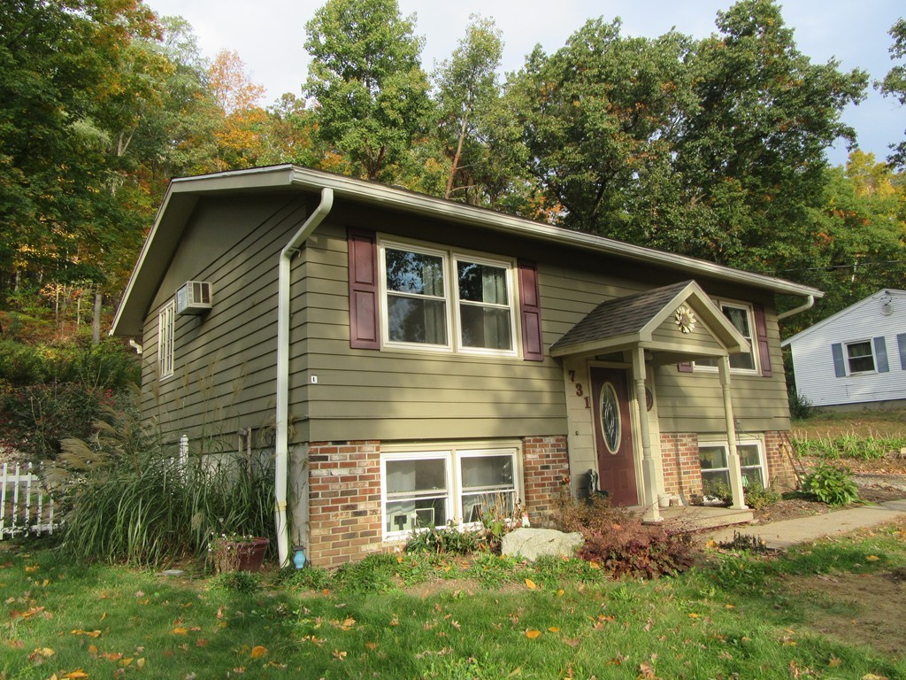 731 Florence Road Northampton, MA 01062 - Photo 1 of 29 a front view of a house with a garden