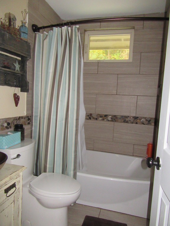 731 Florence Road Northampton, MA 01062 - Photo 15 of 29 a bathroom with a sink a toilet and a bathtub