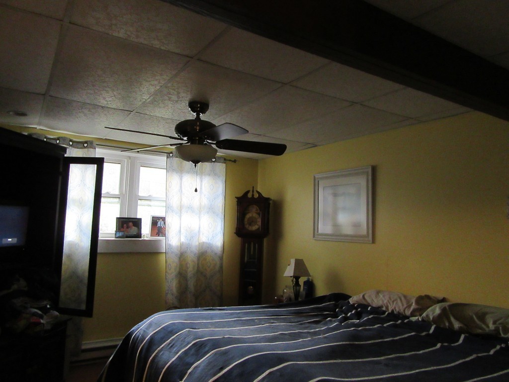 731 Florence Road Northampton, MA 01062 - Photo 23 of 29 a bedroom with a bed and wooden floor