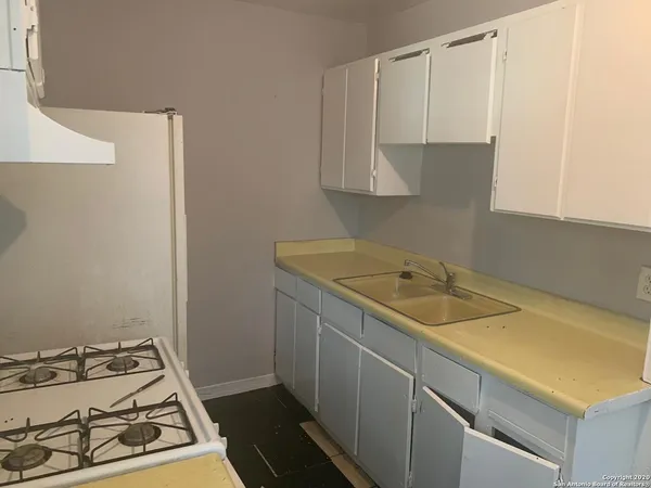 a utility room with sink and cabinets