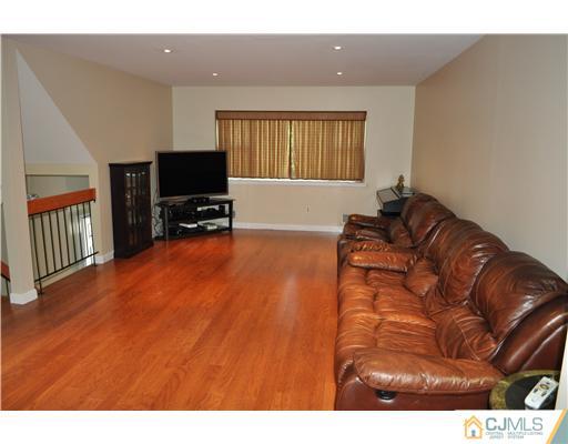 7104 Hana Road Edison, NJ 08817 - Photo 3 of 10 a living room with a couch and a flat screen tv