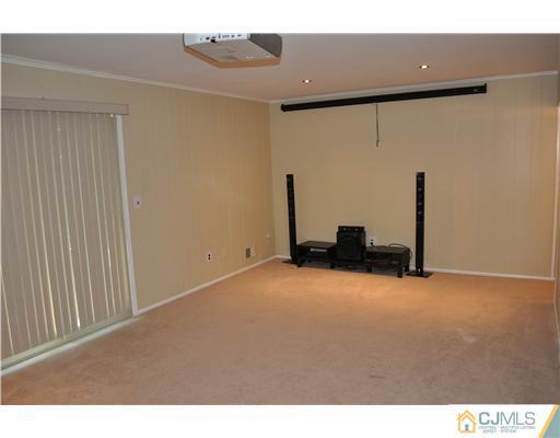 7104 Hana Road Edison, NJ 08817 - Photo 9 of 10 a view of an empty room with wooden floor