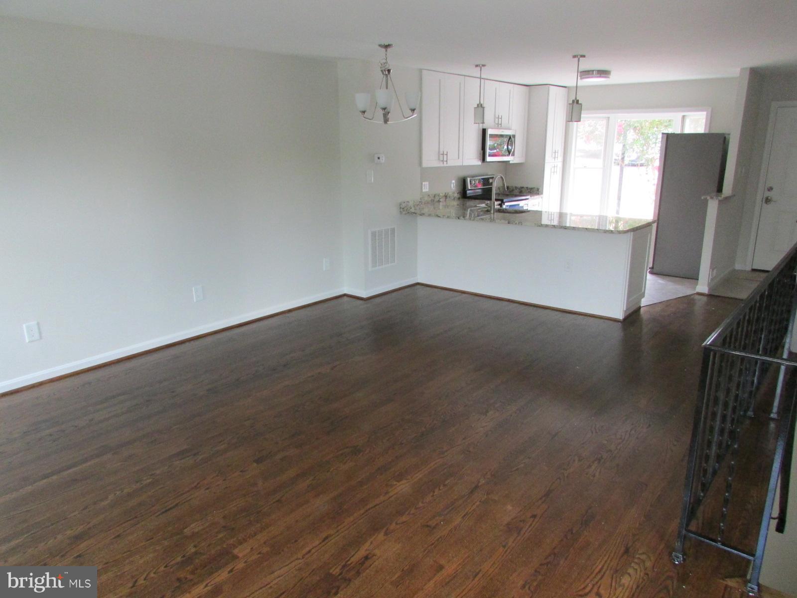 2029 South Glebe Road Arlington, VA 22206 - Photo 3 of 14 a view of a kitchen with wooden floor and electronic appliances