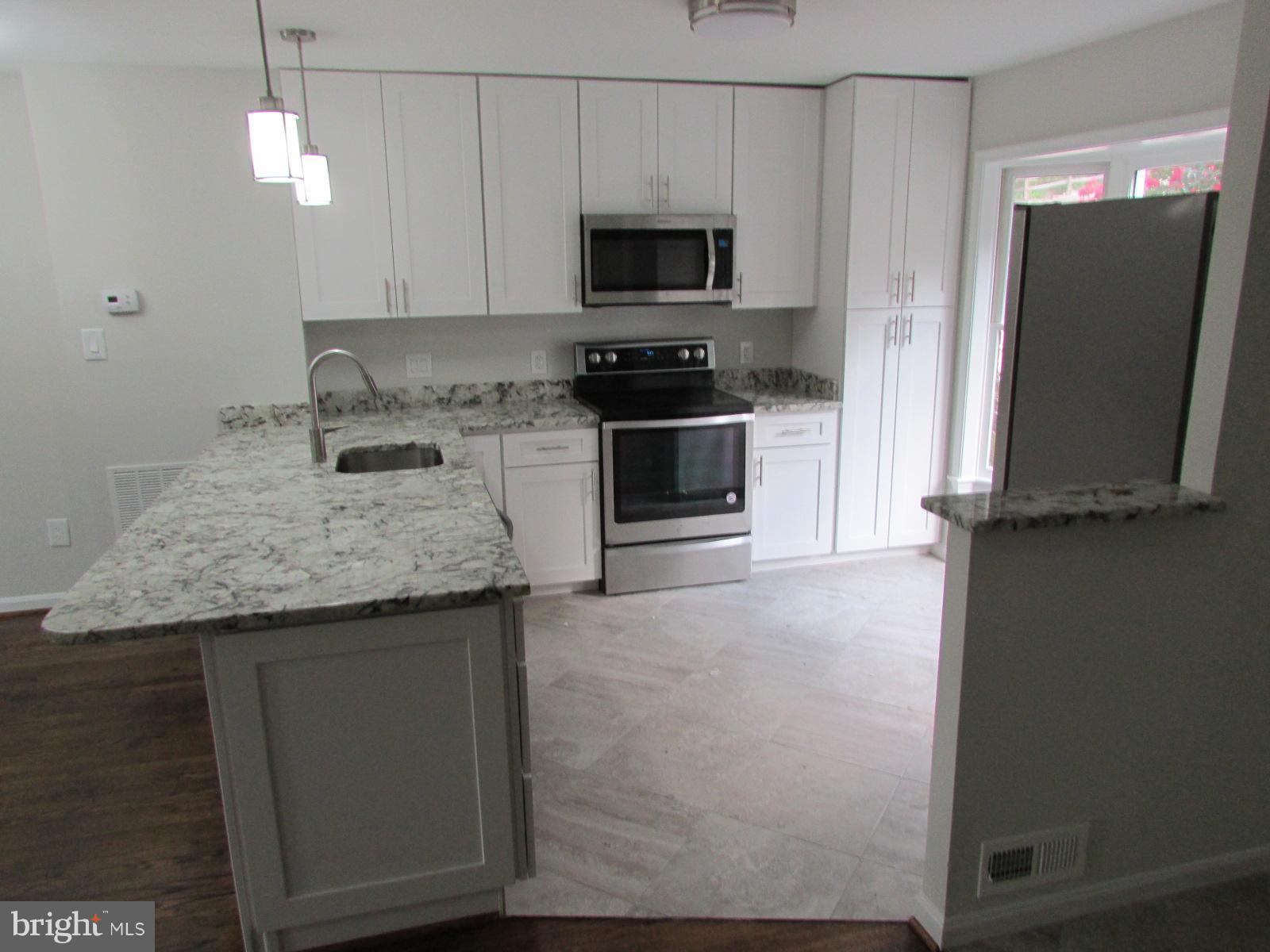 2029 South Glebe Road Arlington, VA 22206 - Photo 5 of 14 a kitchen with granite countertop a sink and a stove top oven