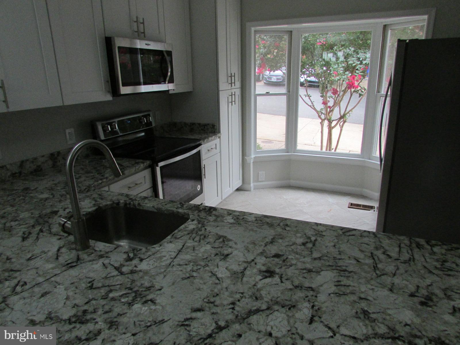 2029 South Glebe Road Arlington, VA 22206 - Photo 6 of 14 a bathroom with a sink a window and a mirror