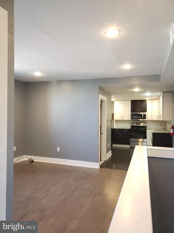 a kitchen with a sink a stove a refrigerator a microwave and cabinets