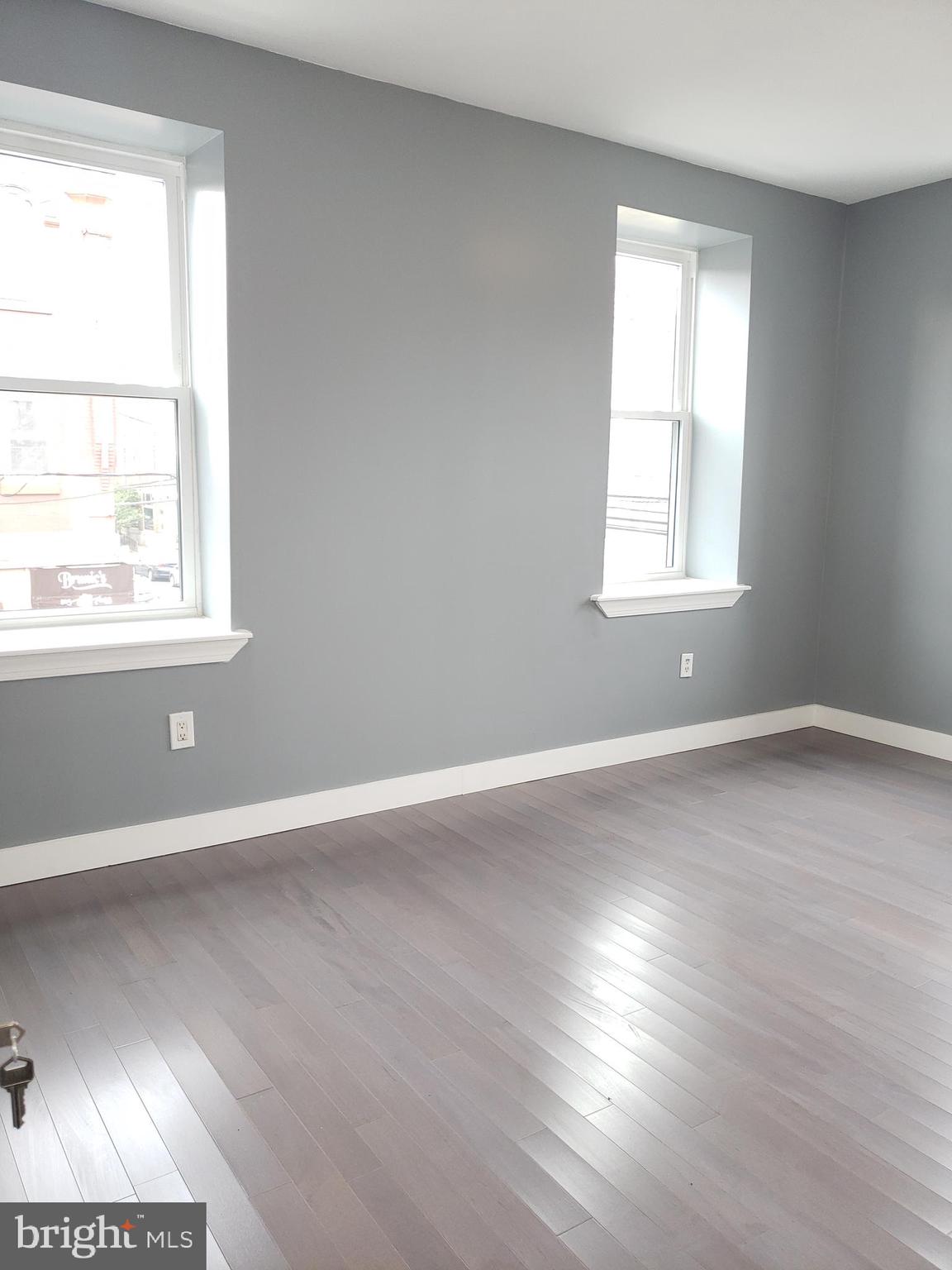 2001 South 17th Street, Unit 3 Philadelphia, PA 19145 - Photo 6 of 13 an empty room with wooden floor and windows
