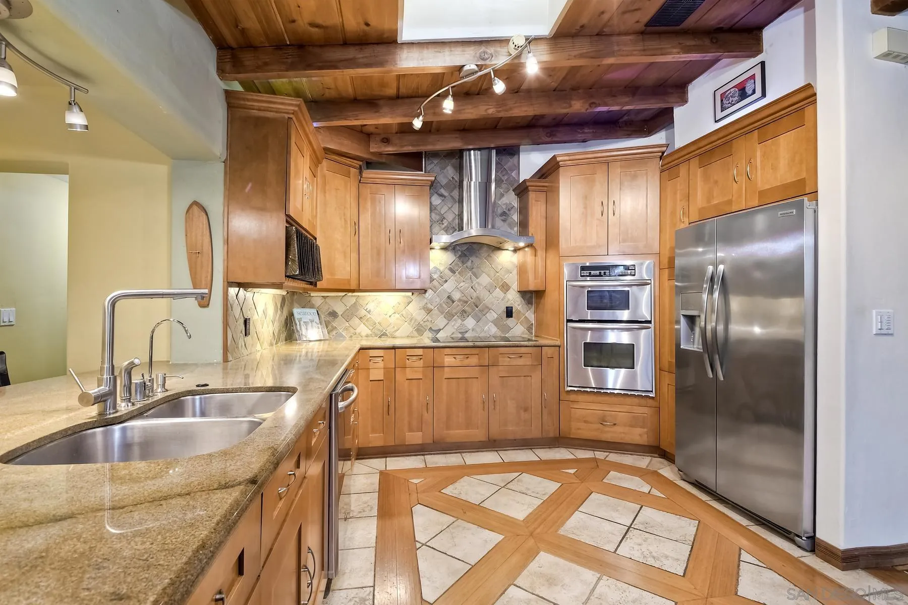 536 Saxony Road Encinitas, CA 92024 - Photo 11 of 57 a kitchen with stainless steel appliances granite countertop a sink and a refrigerator