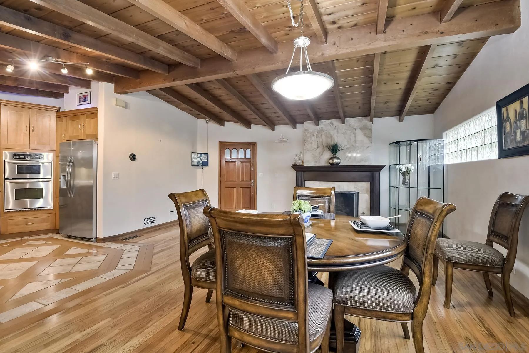 536 Saxony Road Encinitas, CA 92024 - Photo 18 of 57 a dining room with furniture a fireplace and wooden floor