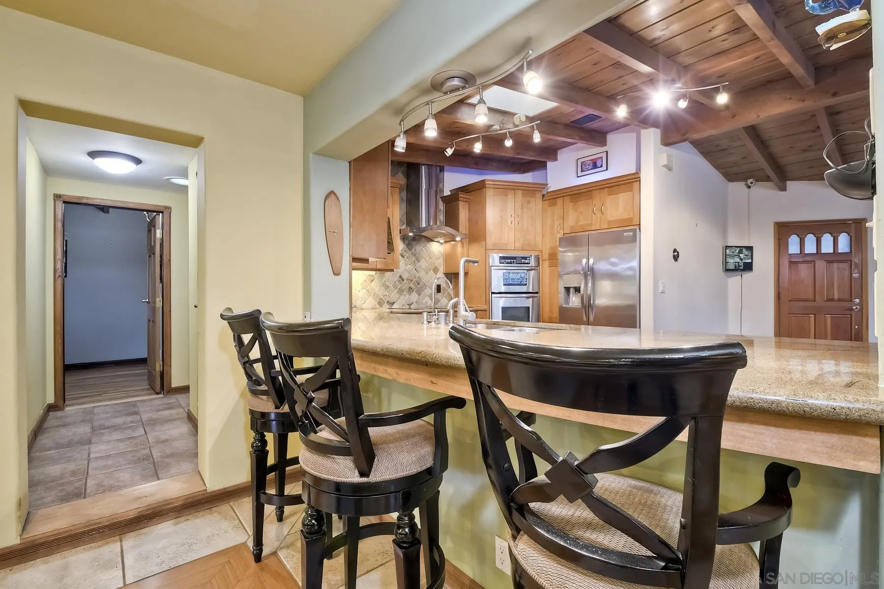 536 Saxony Road Encinitas, CA 92024 - Photo 20 of 57 a view of a dining room with furniture and chandelier