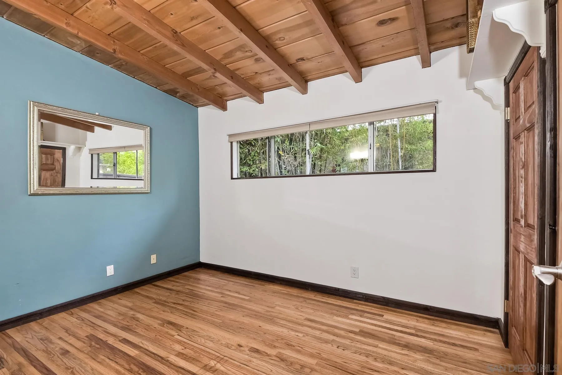 536 Saxony Road Encinitas, CA 92024 - Photo 34 of 57 a view of an empty room with wooden floor and a window
