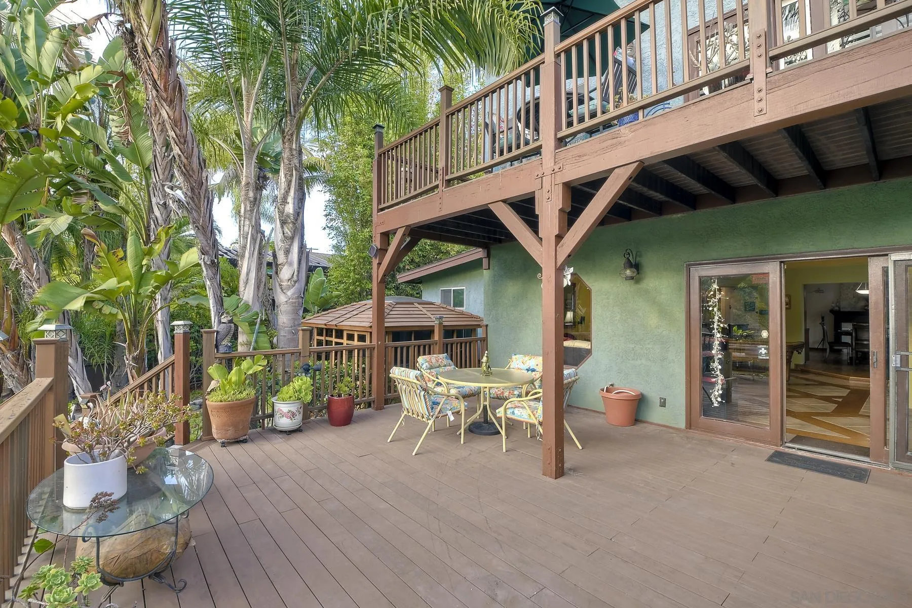536 Saxony Road Encinitas, CA 92024 - Photo 40 of 57 a view of a patio with table and chairs and potted plants