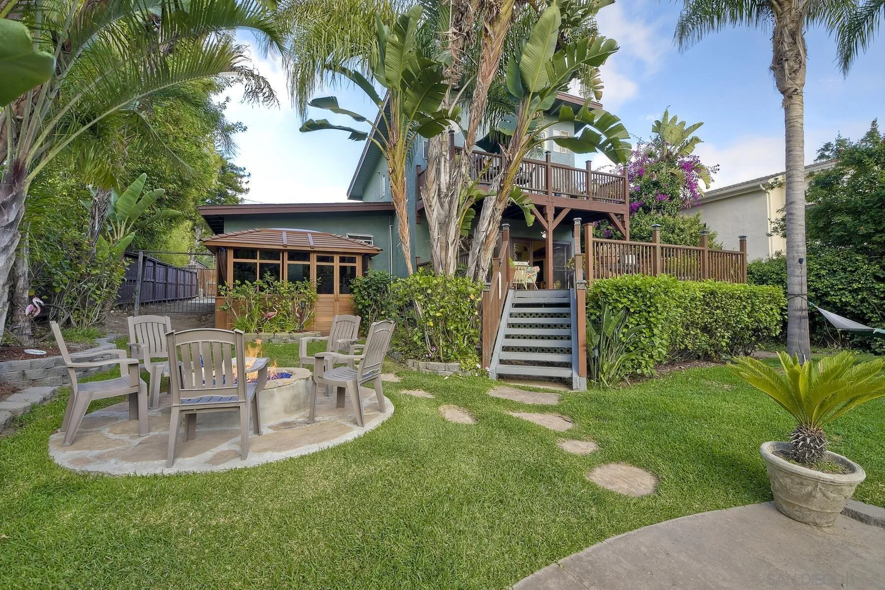 536 Saxony Road Encinitas, CA 92024 - Photo 42 of 57 a view of a chair and table in backyard of the house