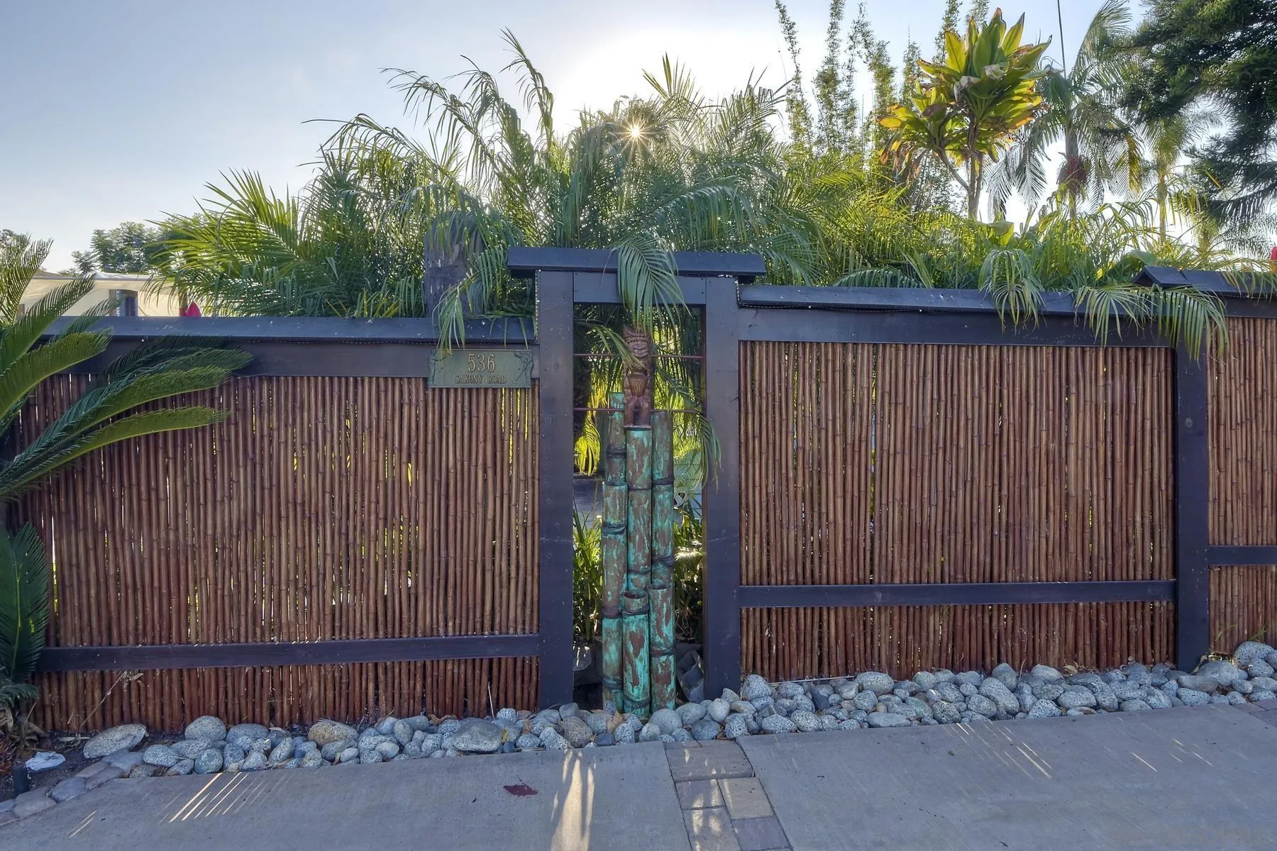 536 Saxony Road Encinitas, CA 92024 - Photo 6 of 57 a backyard of a house with plants and wooden fence