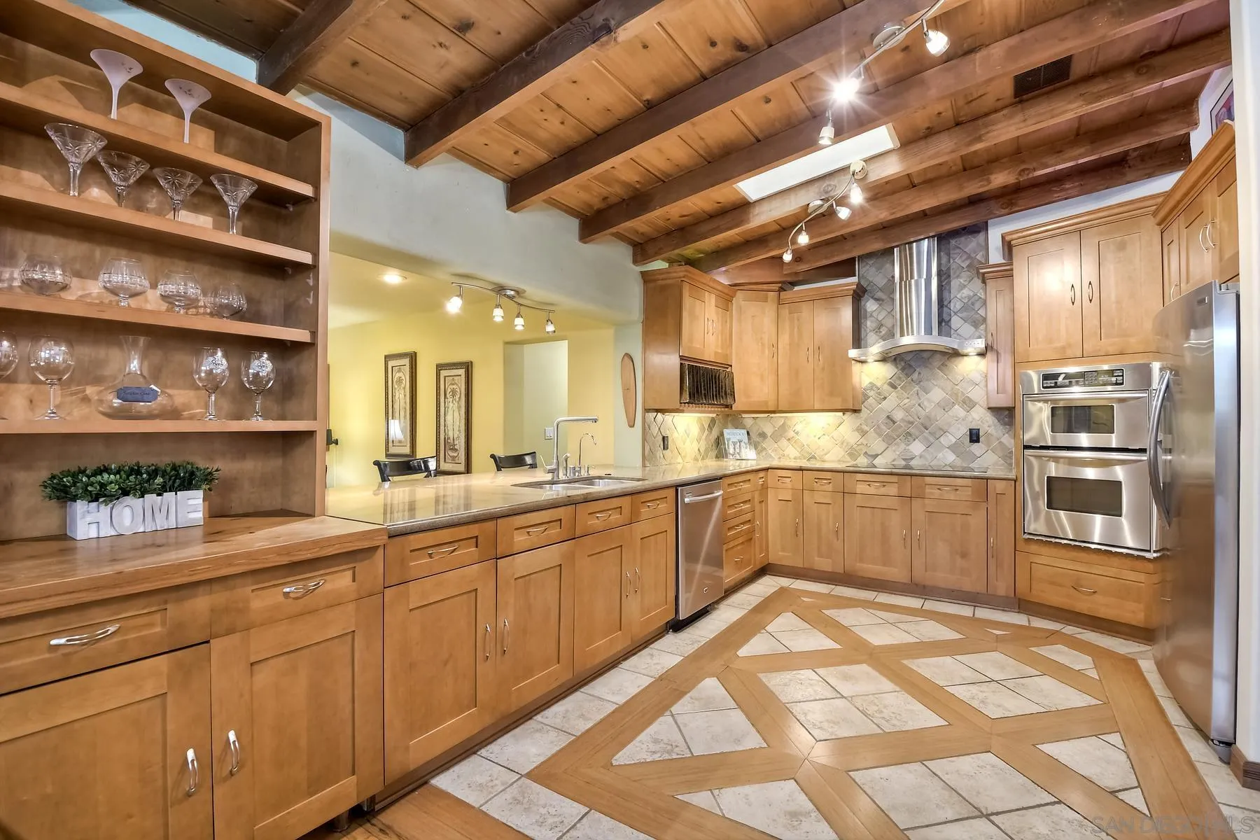536 Saxony Road Encinitas, CA 92024 - Photo 10 of 57 a large kitchen with stainless steel appliances a large counter top a stove and a refrigerator