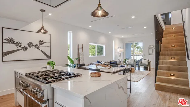 a kitchen with a stove a sink and a refrigerator
