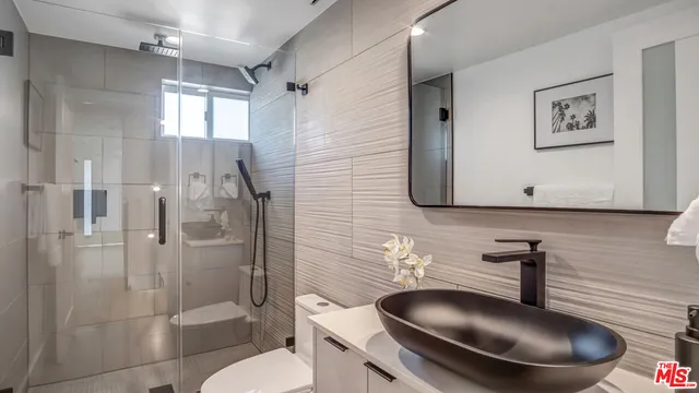 a bathroom with a toilet sink and shower