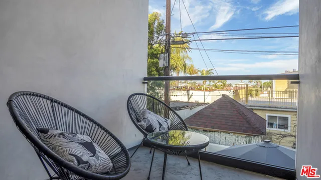 a view of a balcony with furniture